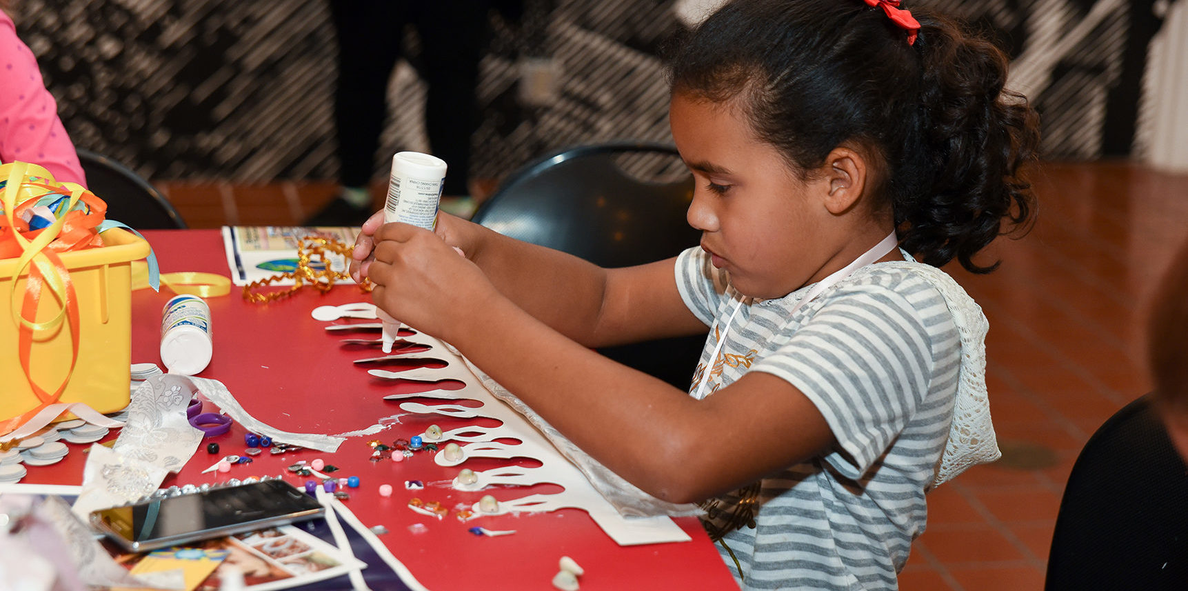 child making art with textiles