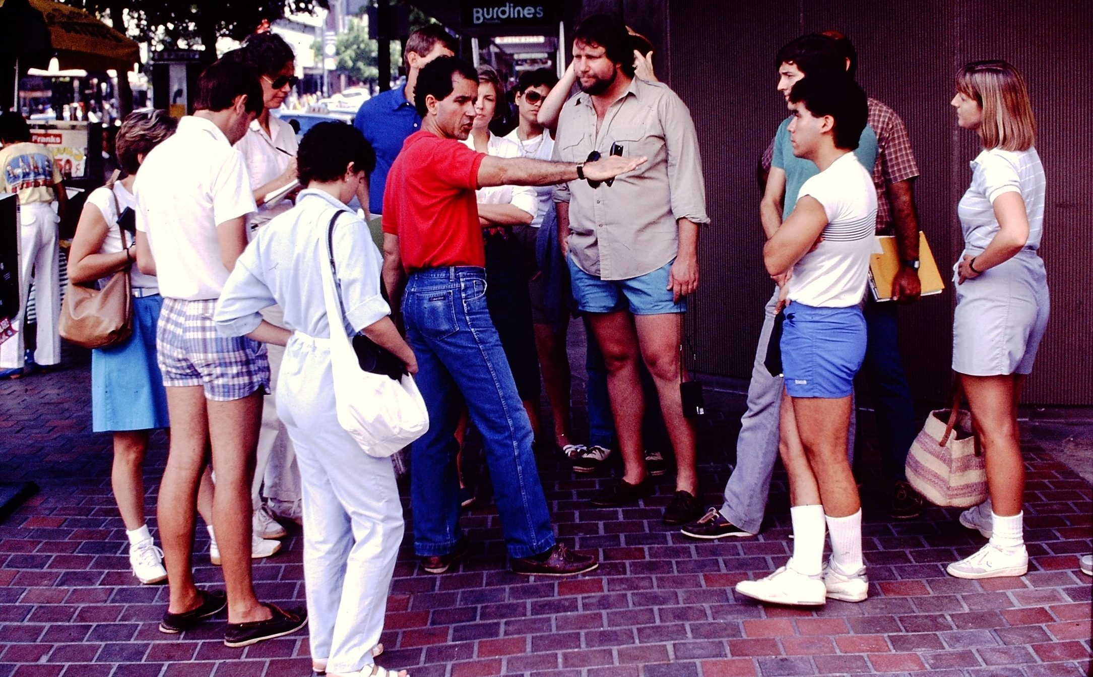 Tour group with Dr. George in Downtown Miami. Dr. George is wearing a red shirt and blue jeans.