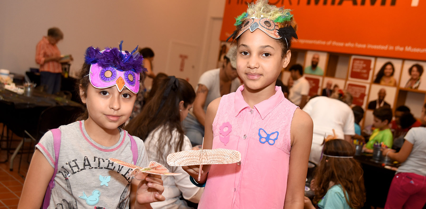 Two girls holding their bird crafts
