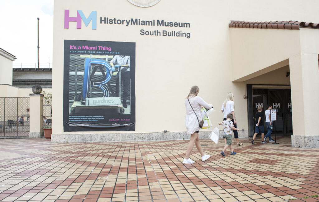 Adults and Children walking toward the front doors of a building