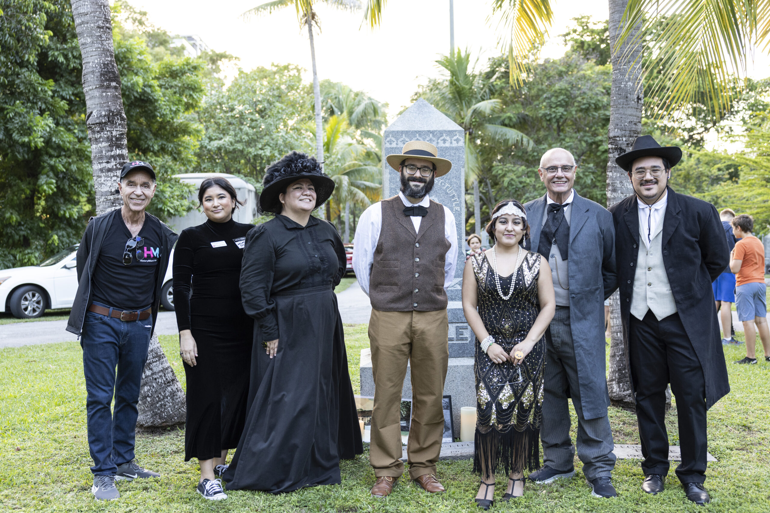 six people standing in a cemetery