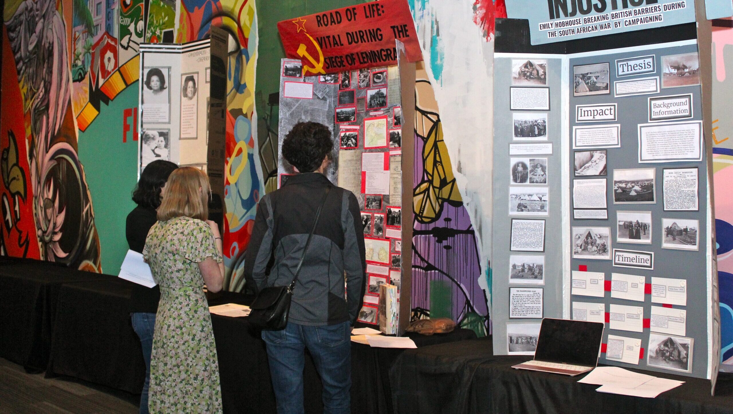 People looking at project board displays