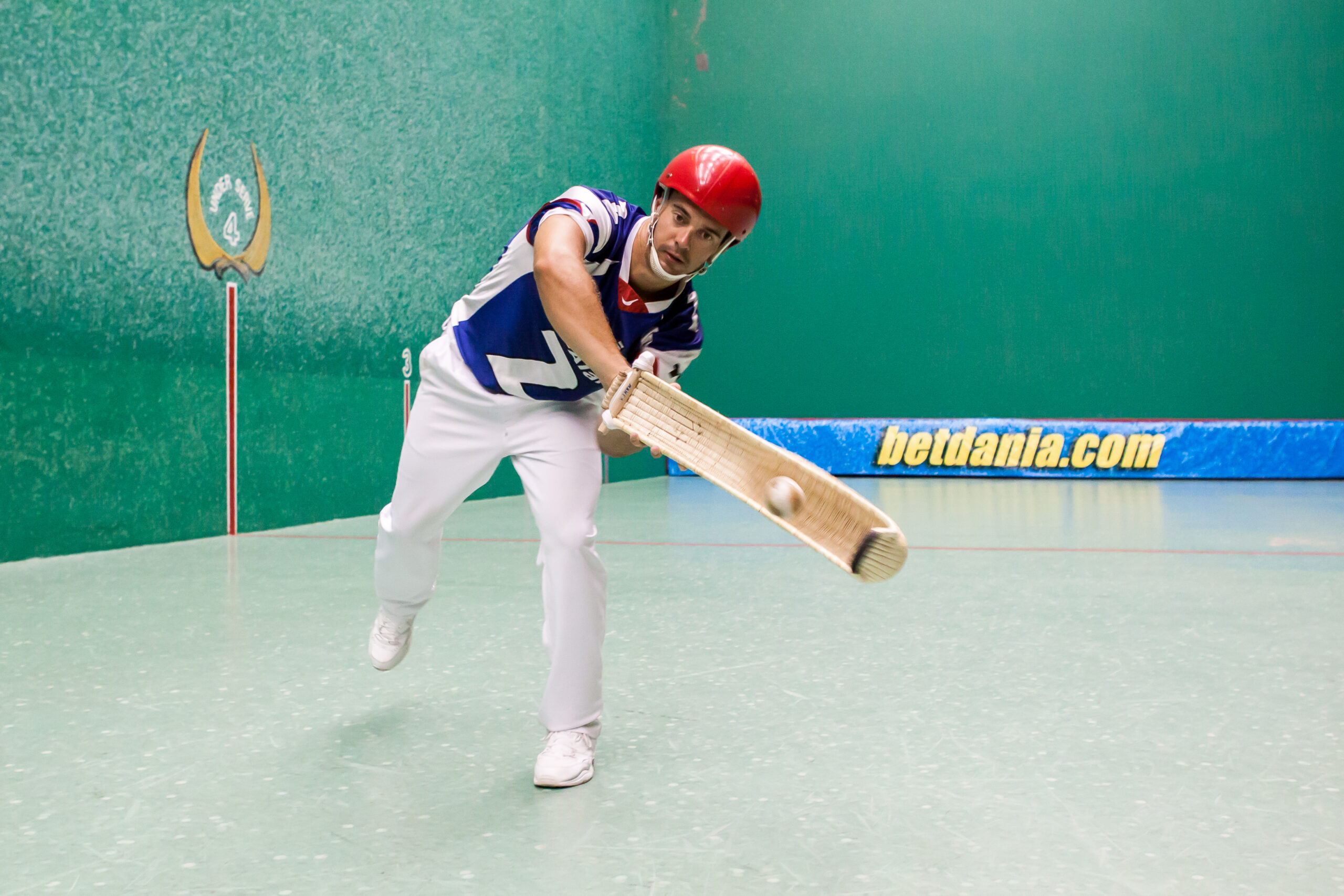 Jai-Alai player, Manex Urtasun throws a ball with a cesta