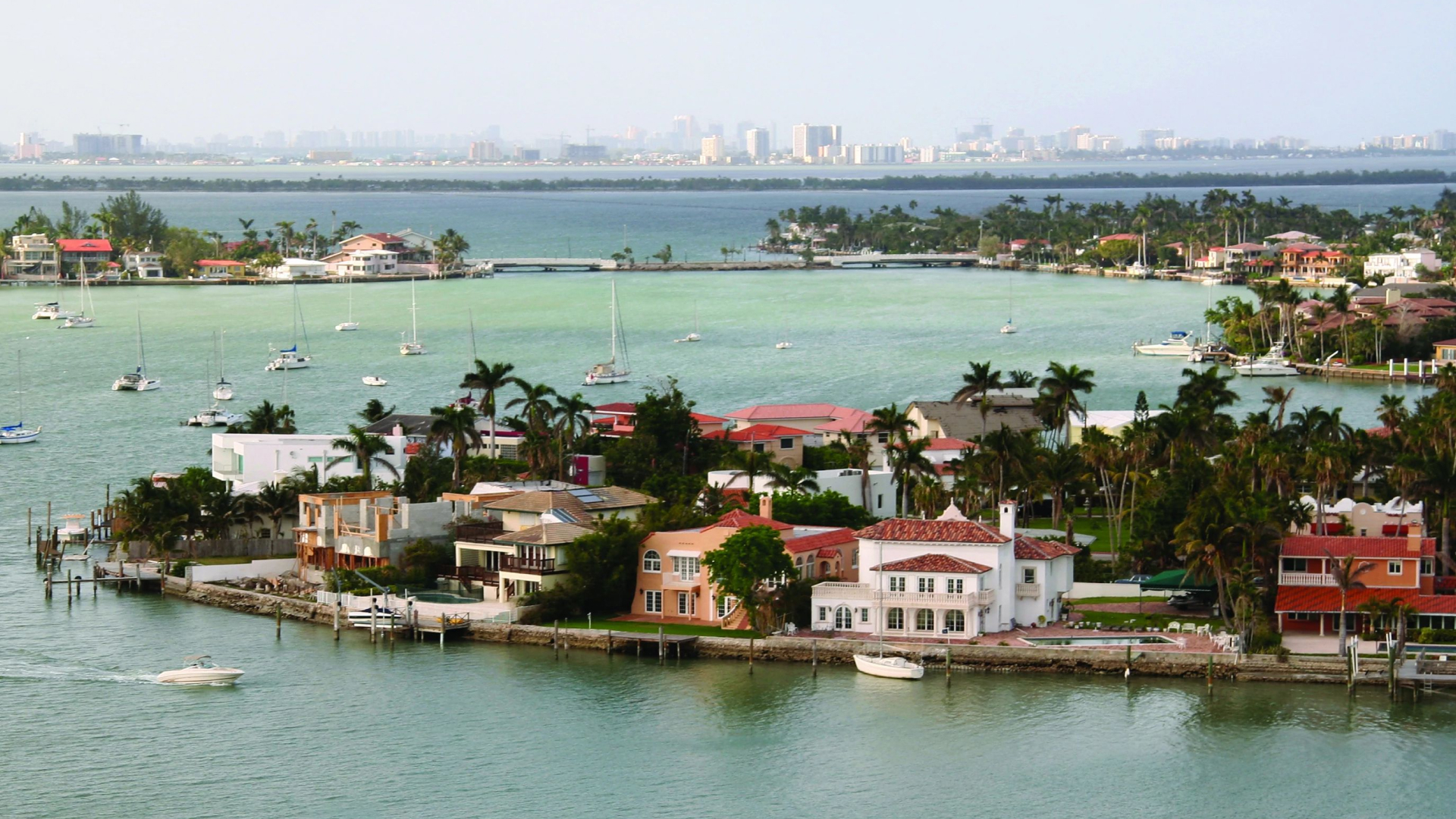 View of Hibiscus Island in Biscayne Bay. Houses can be seen dotted along the shoreline near blue waters. Mansions - Hibiscus Island, 2013. Kiko Ricote, photographer. Photo courtesy of the GMCVB – http://MiamiandMiamiBeach.com