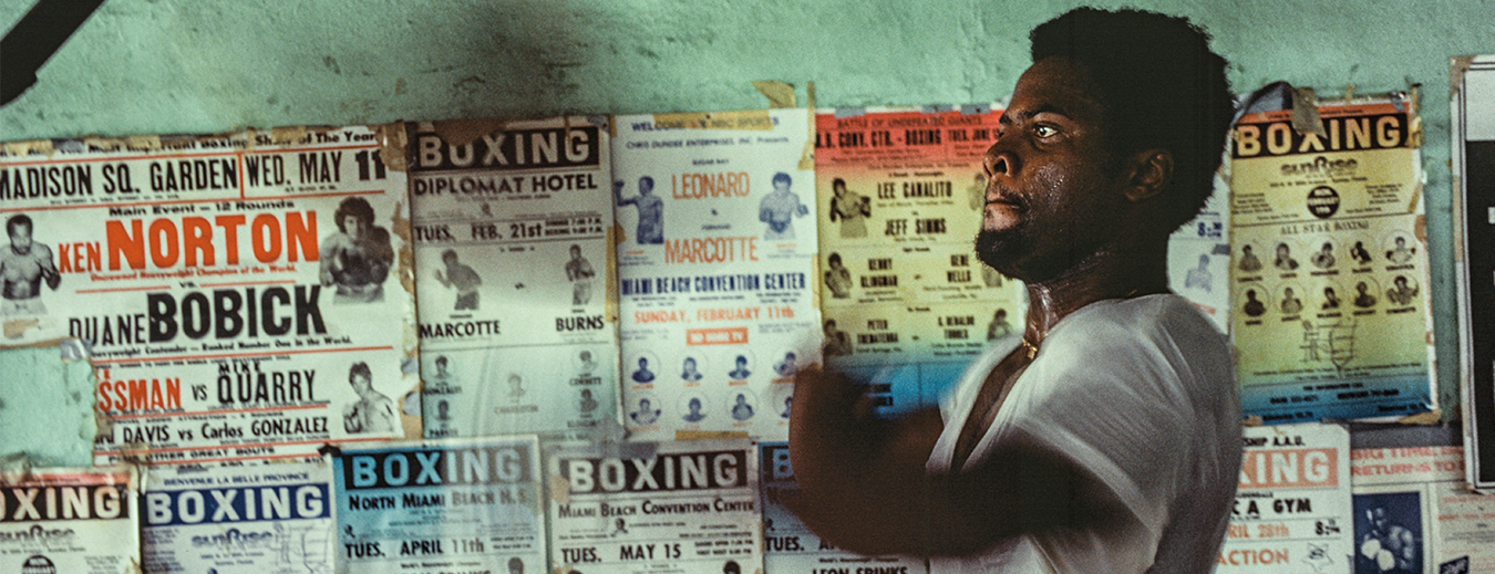 man in front of posters