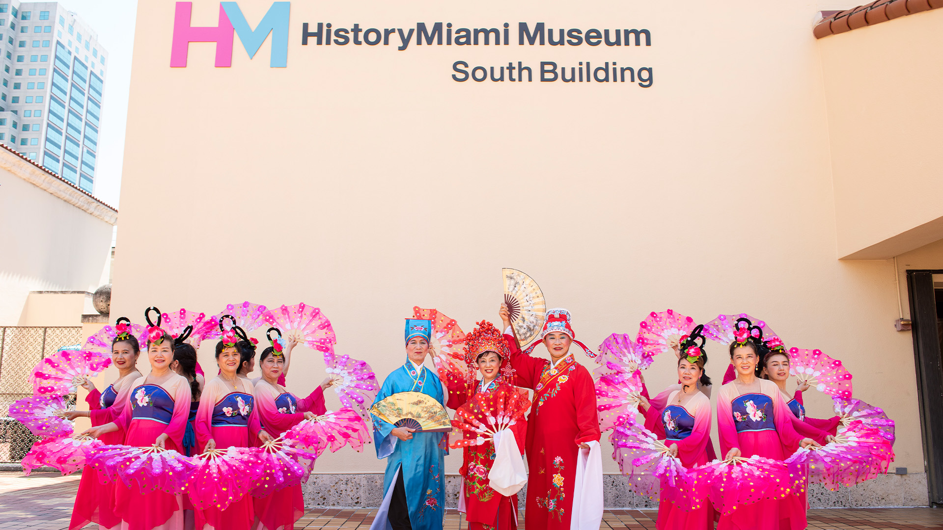 Chinese dancers in front of museum building.
