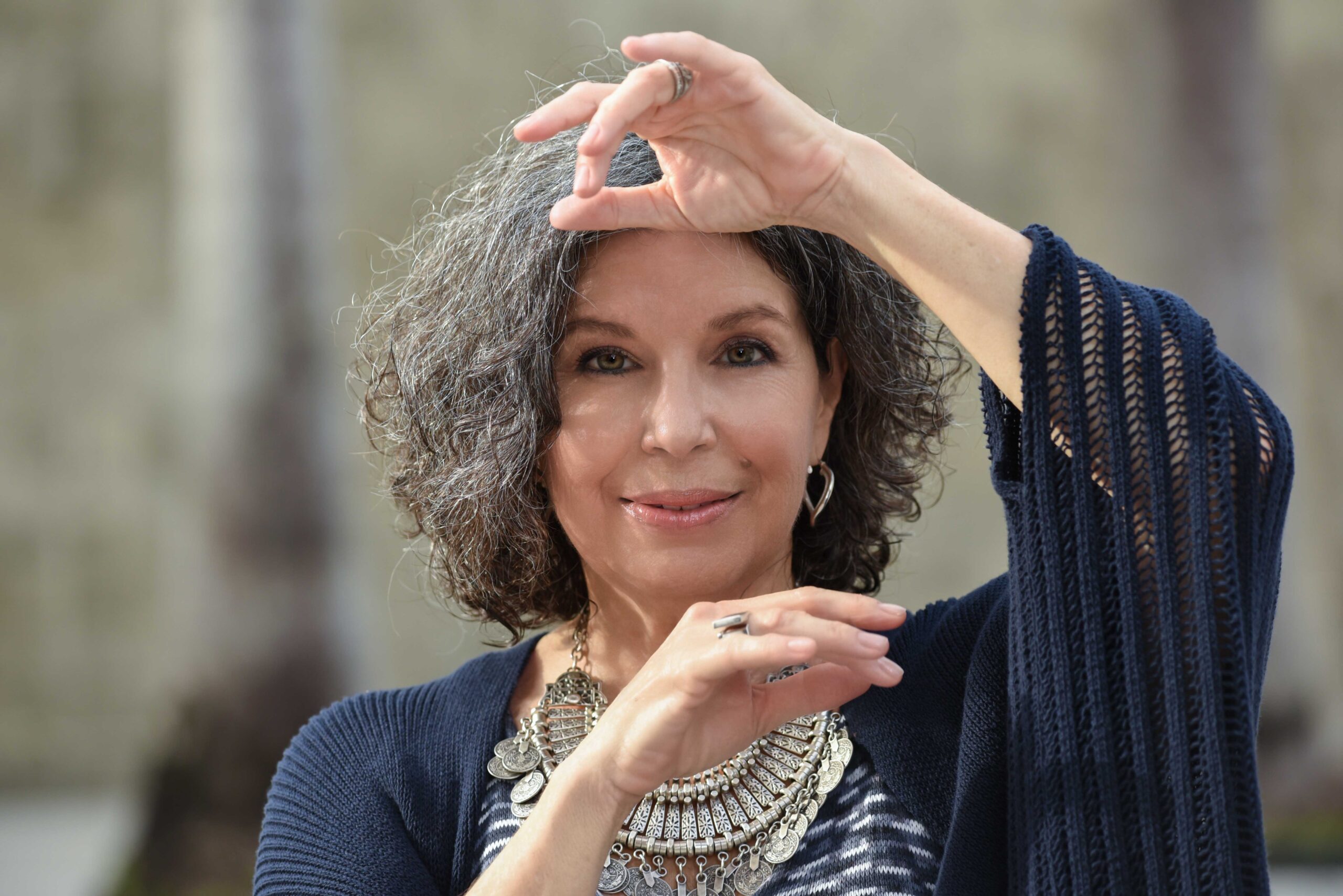 A close up shot of Susana Behar with one arm over her head and one under her chin