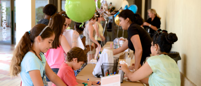 group doing crafts with balloons strewn about