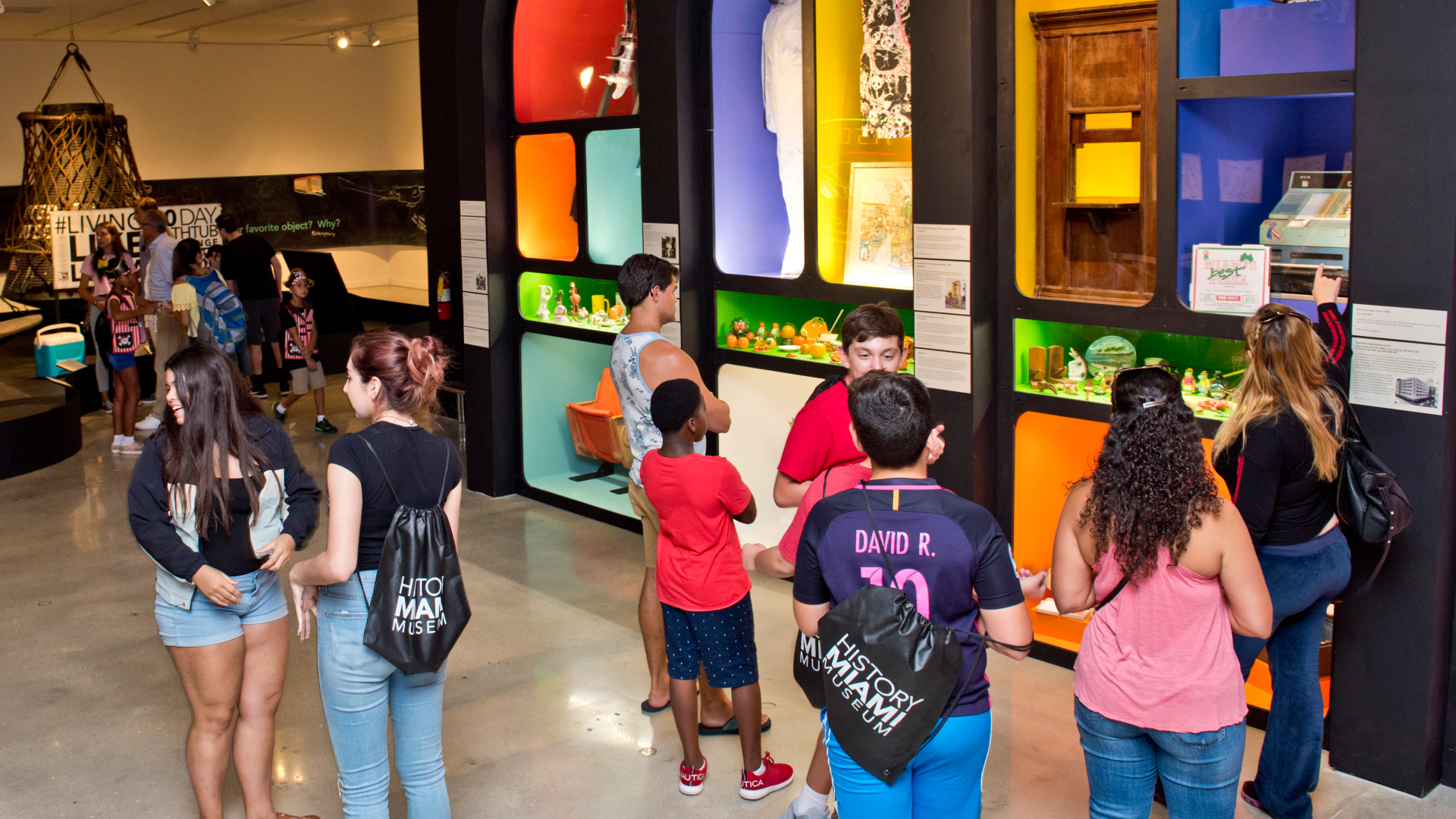 Museum visitors looking at exhibition cases.